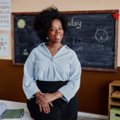Portrait of Smiling Primary School Teacher in Classroom