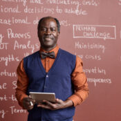 Black Senior College Professor Wearing Bowtie and Smiling at Camera